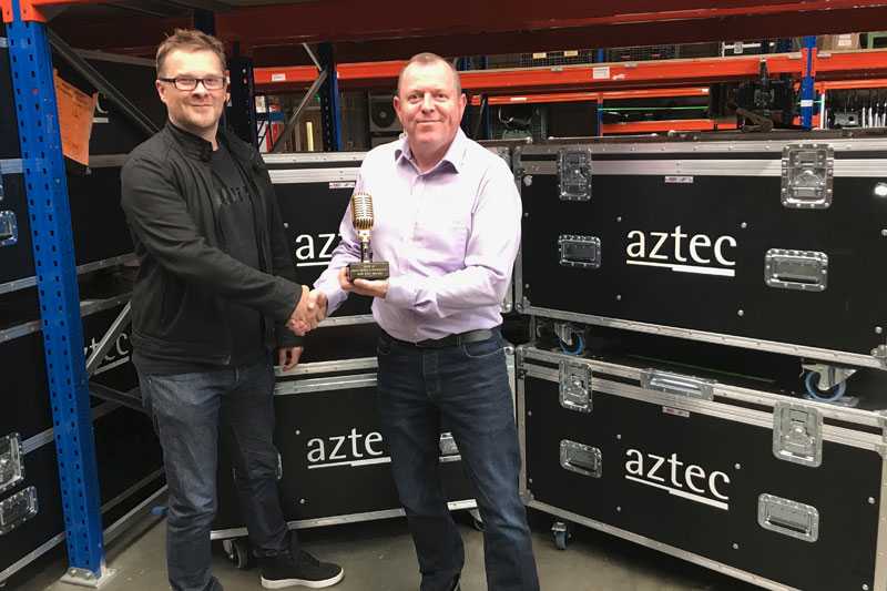 Stuart Moots of Shure hands the award to Aztec's Steve Colesell