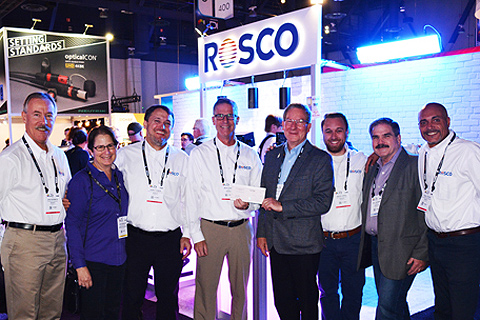 Mark Engel and Rosco staff members present a cheque to Behind the Scenes chair Rick Rudolph