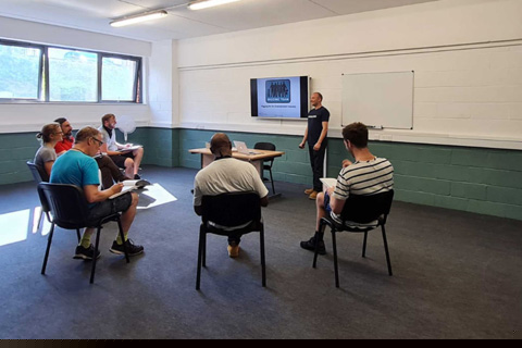 The centre features a generous classroom and presentation space, along with a practical training area