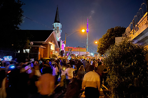 The community-led parade winds through the streets and features singers, dancers and bands