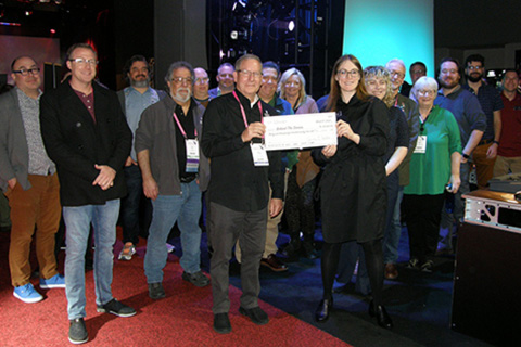 Kate Foster and ETC's employee owners present a check to BTS chair Rick Rudolph and members of the BTS board