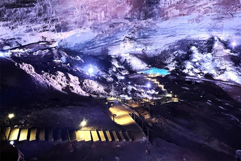 The cave formation is a result of water erosion from the River Loue